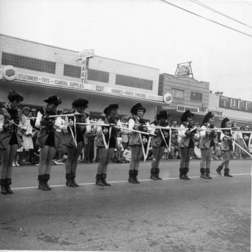 Dee's Mart, Des Moines Electric, and Tuffley's Market Behind Pirate Drill Team