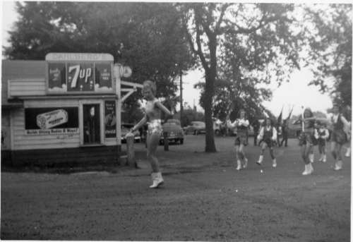 Drill Team Marching by Dahlberg's Store in early Waterland Parade