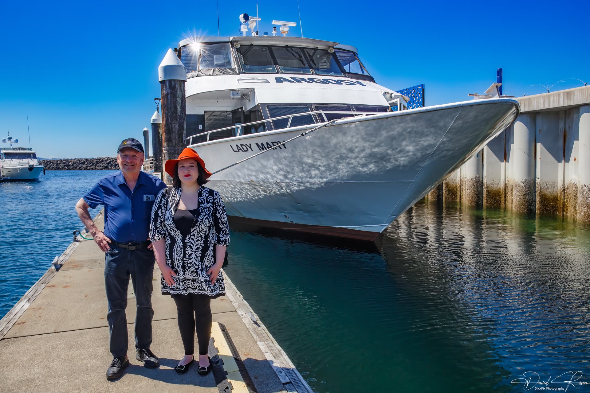 Richard Kennedy DMHS President & VJ Kopacki Executive Director DMHS pose on the dock beside the bow of the Lady Mary.