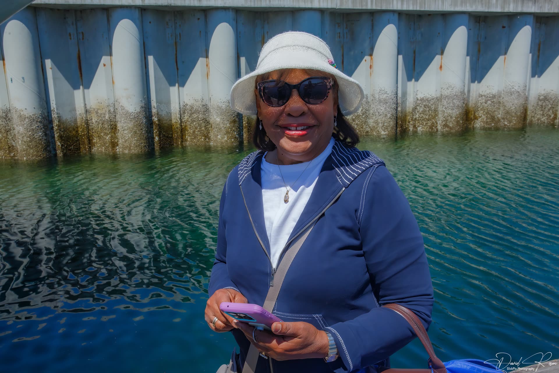 A cruise guest poses near the boarding dock.
