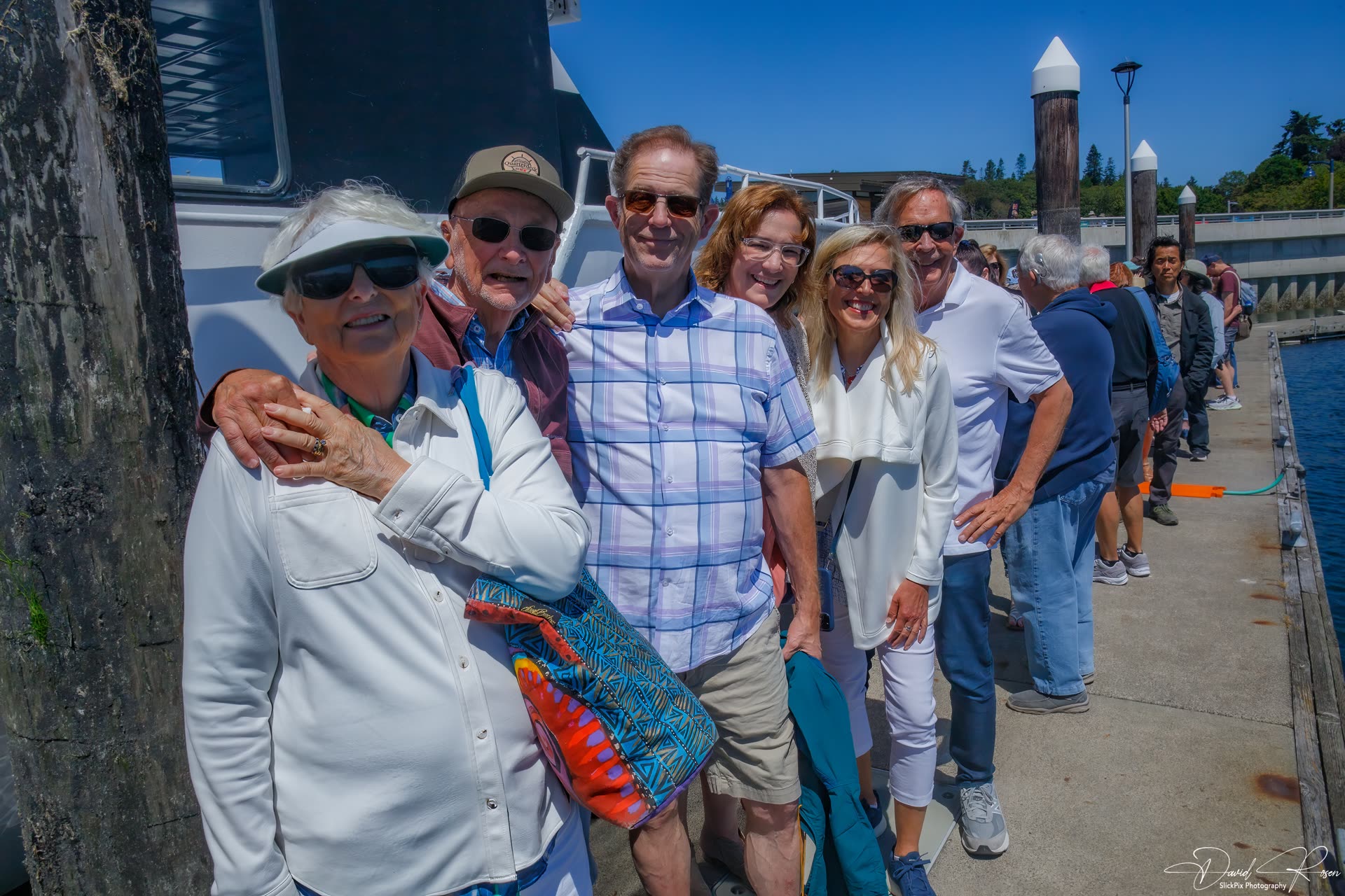 A group of cruise participants poses on the dock.