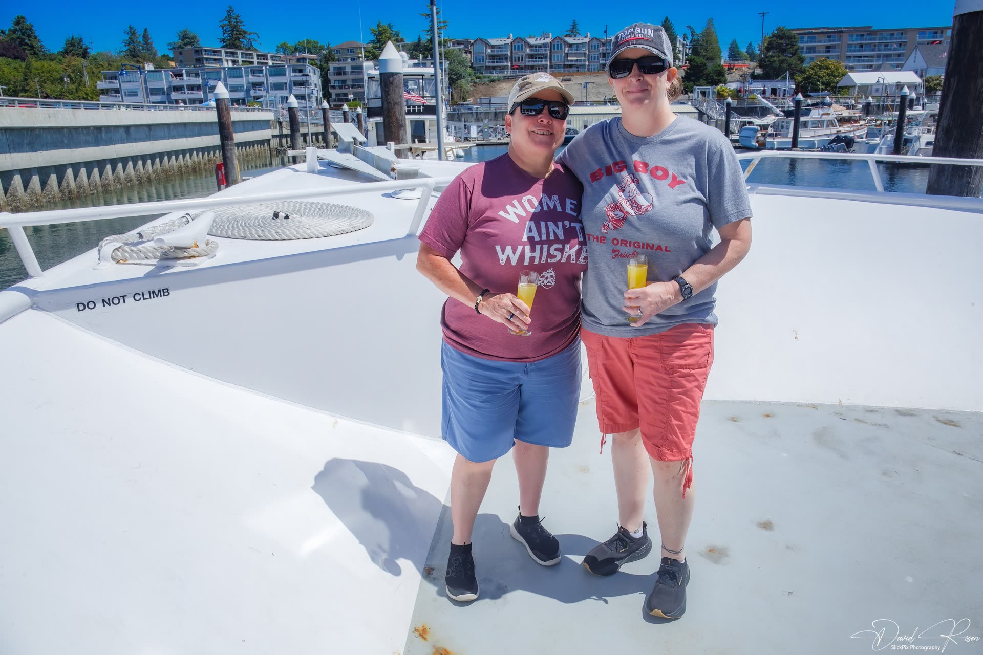 Two guests pose together on the Lady Mary open deck.