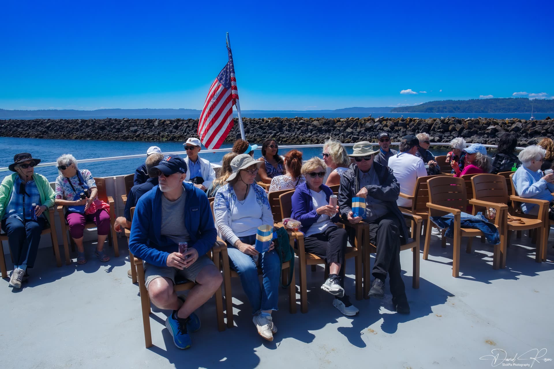 Passengers gather on the open aft deck as the cruise gets underway.