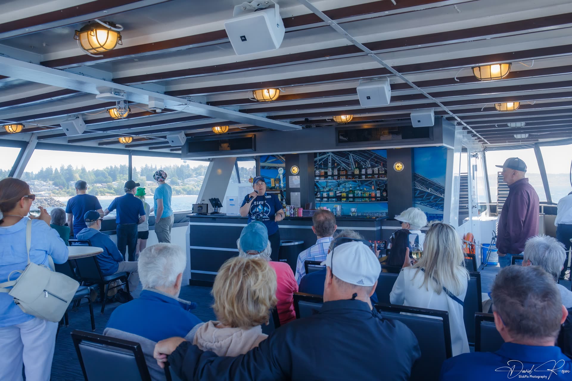 Passengers listen to a presentation inside the Lady Mary cabin.