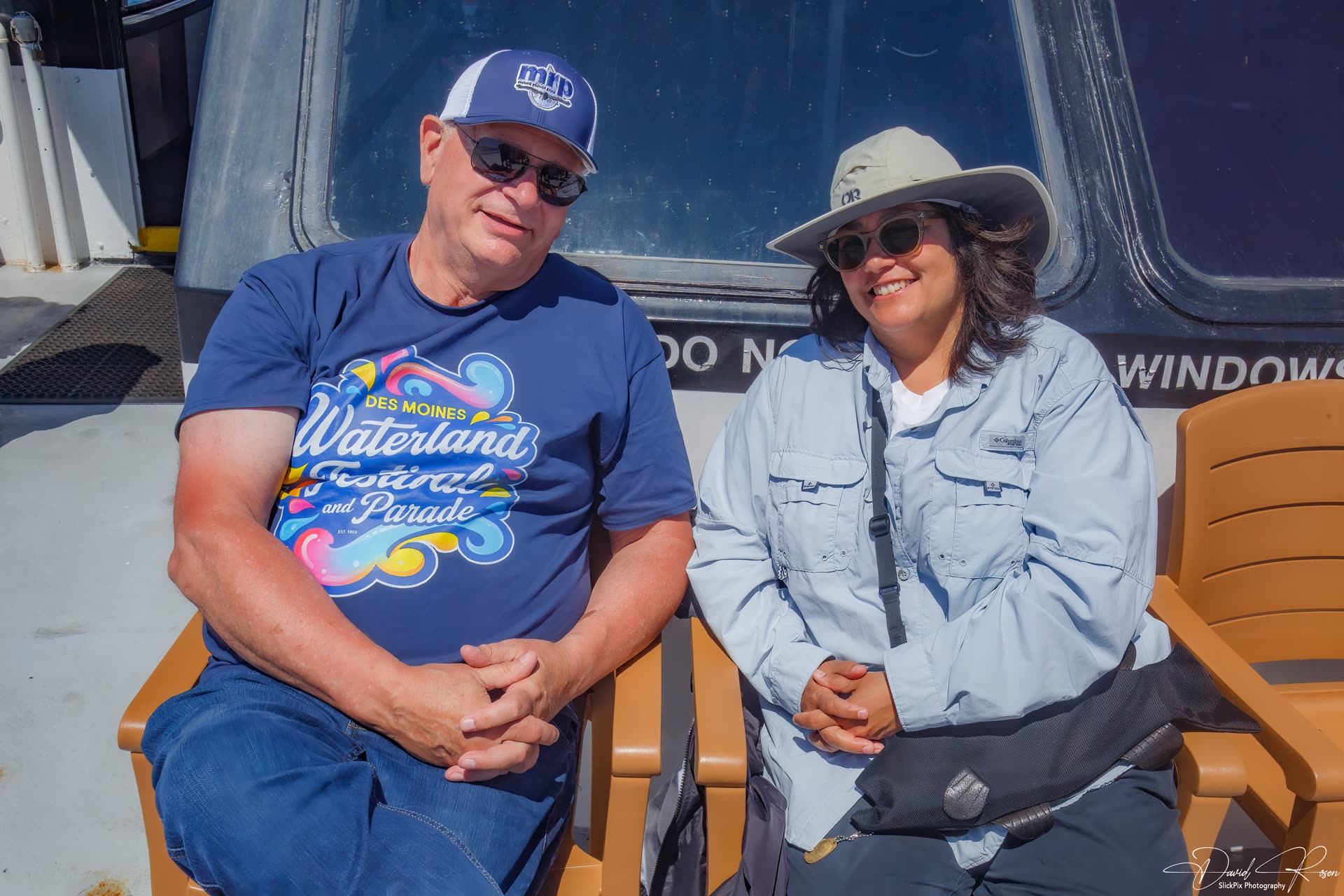 Two guests sit together near a cabin window.