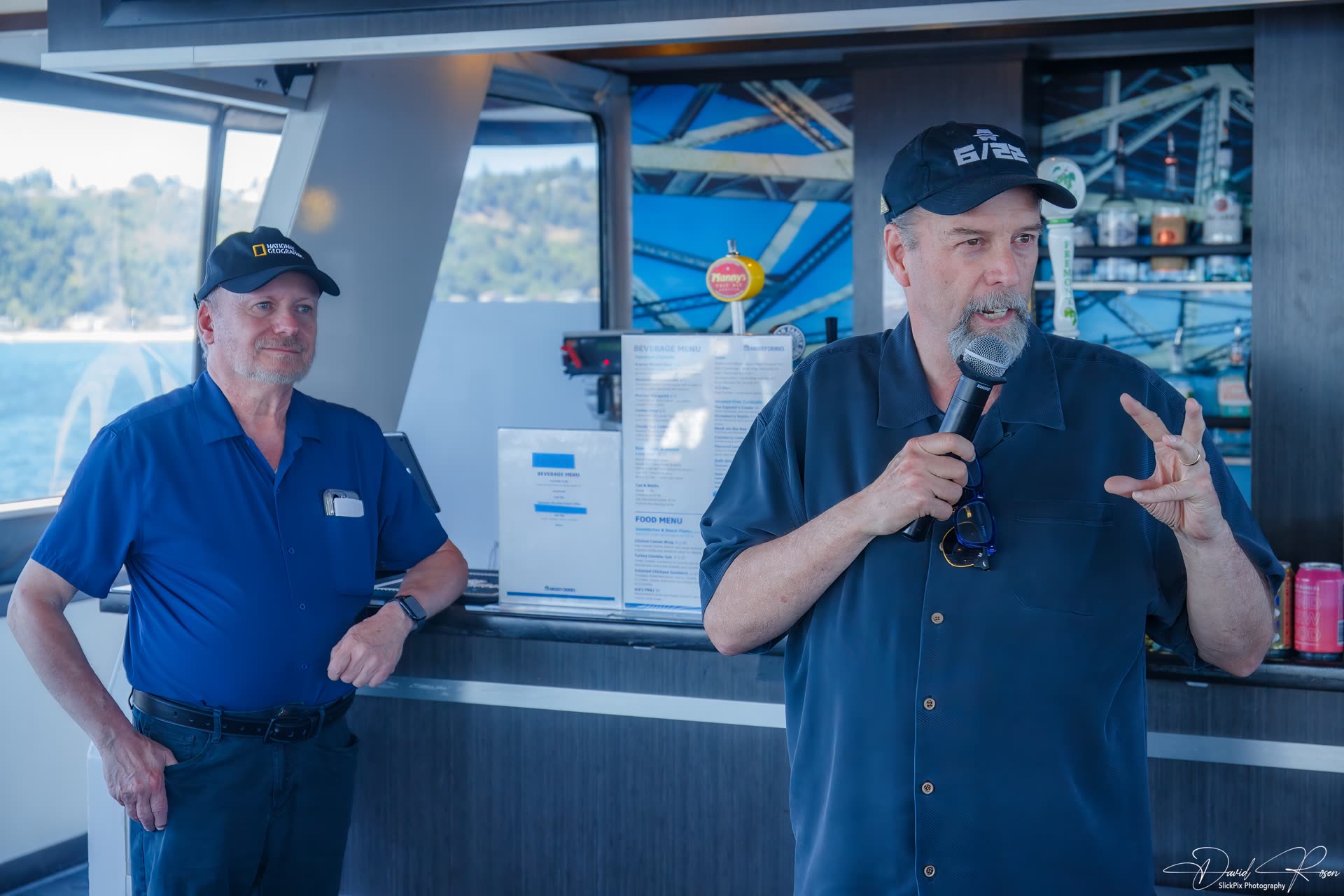 A speaker talks to passengers from the front of the cabin.