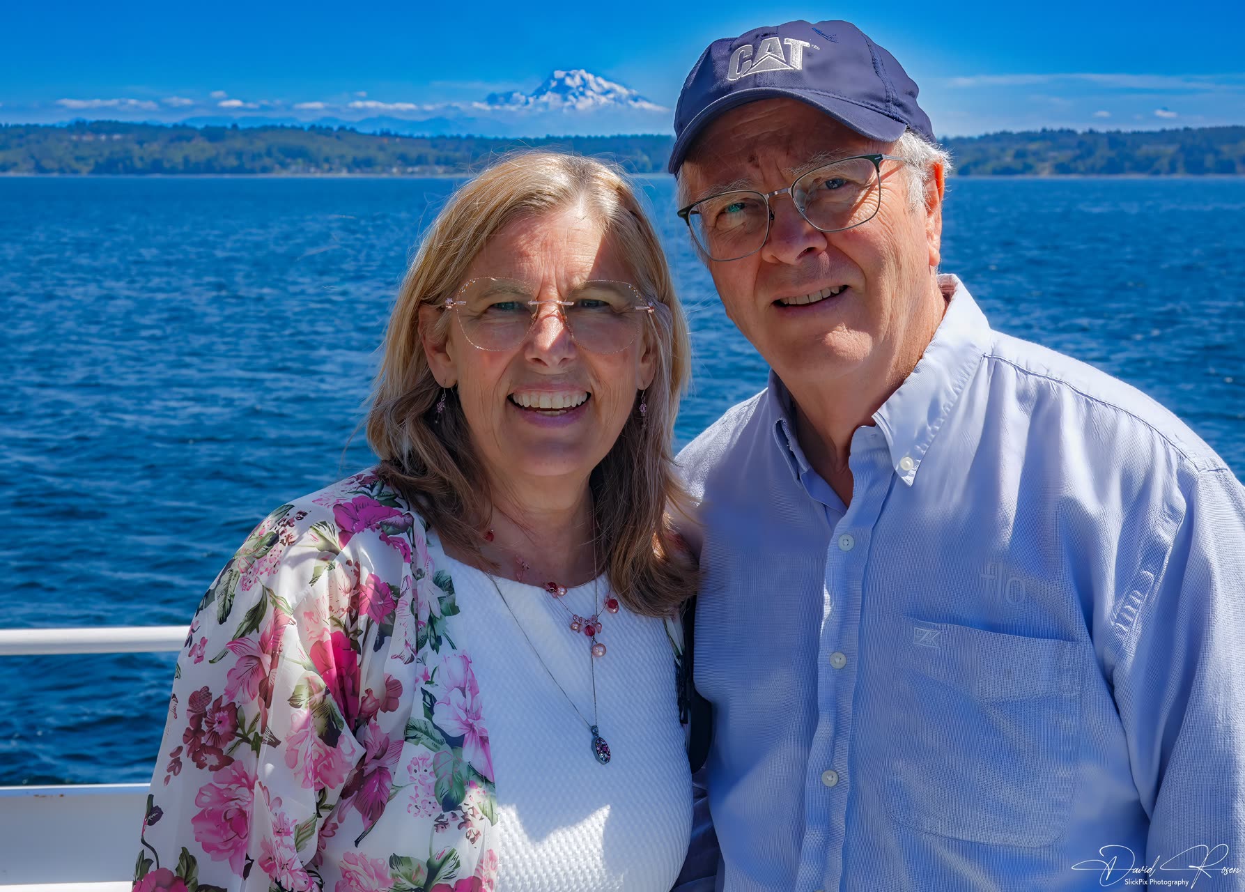 Two guests pose together with Puget Sound behind them.