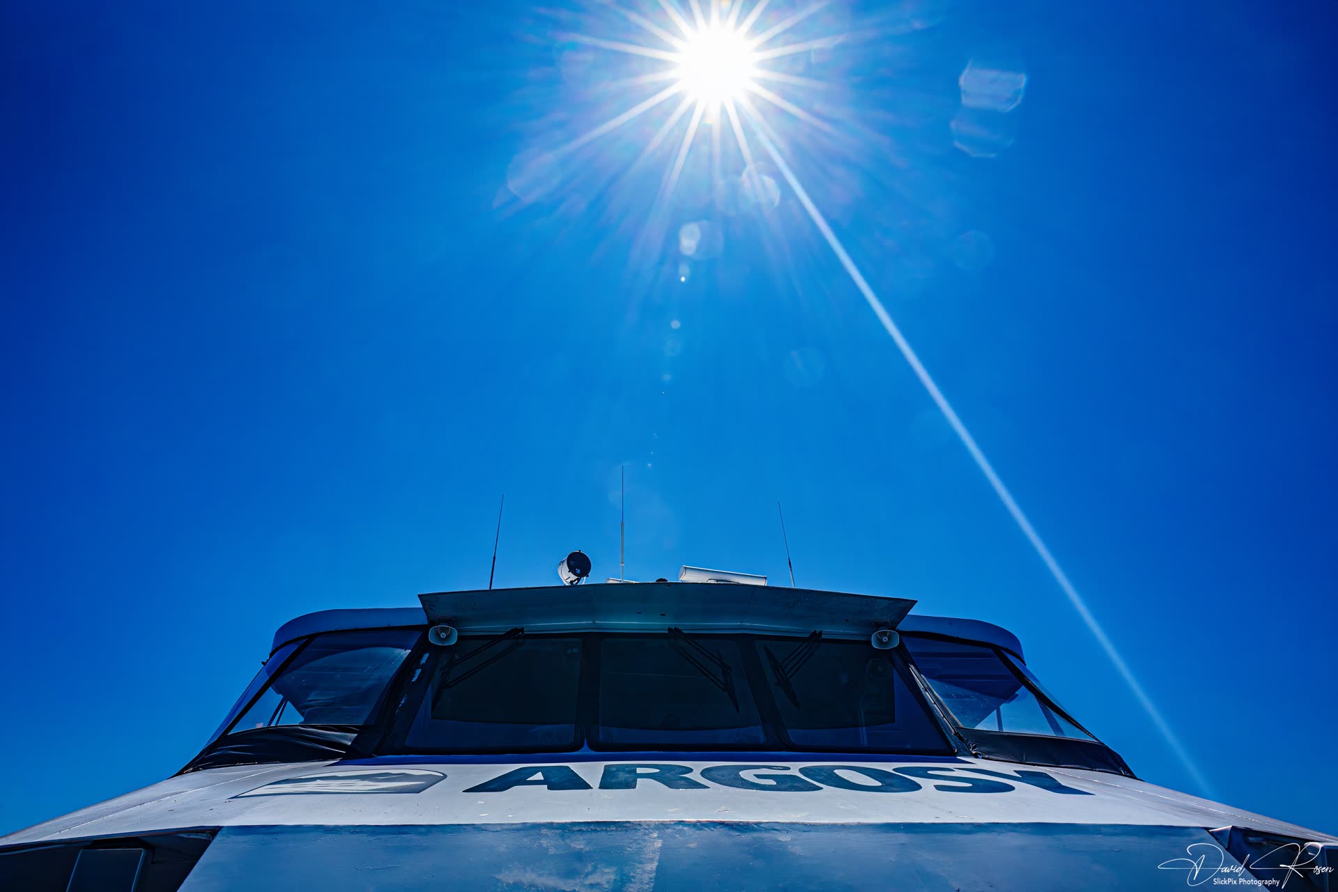 Bright sun shines above the forward roof of the Argosy vessel.